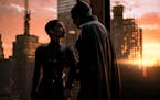 This image released by Warner Bros. Pictures shows Zoe Kravitz, left, and Robert Pattinson in a scene from "The Batman." (Jonathan Olley/Warner Bros. 