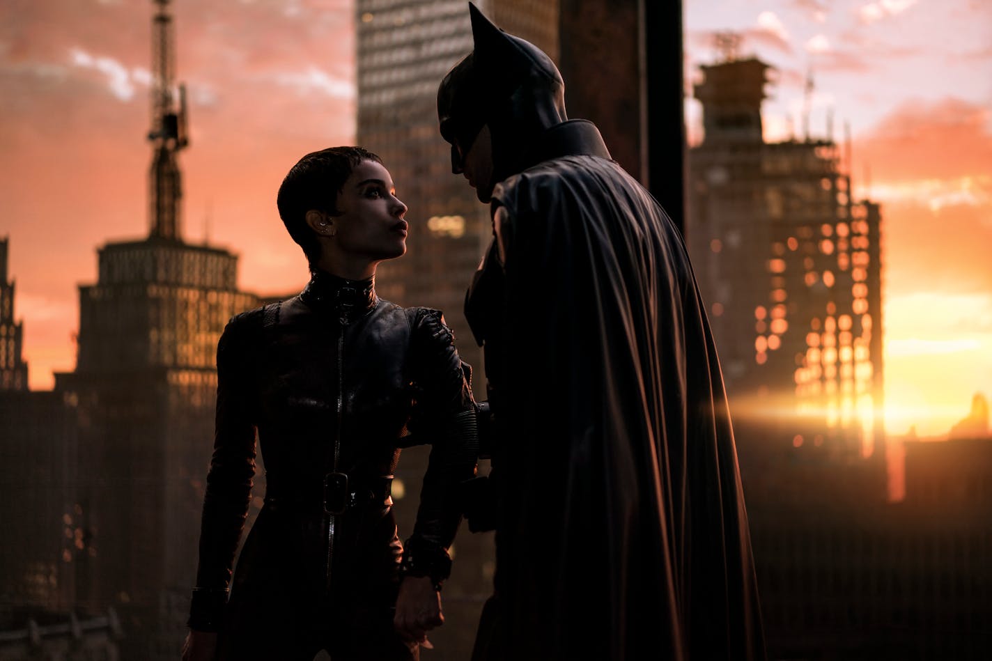 This image released by Warner Bros. Pictures shows Zoe Kravitz, left, and Robert Pattinson in a scene from "The Batman." (Jonathan Olley/Warner Bros. Pictures via AP)