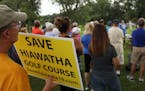 Golfers and supporters of the Hiawatha Golf Course held signs as they rallied against the Park Board's recent decision to reduce pumping and close the