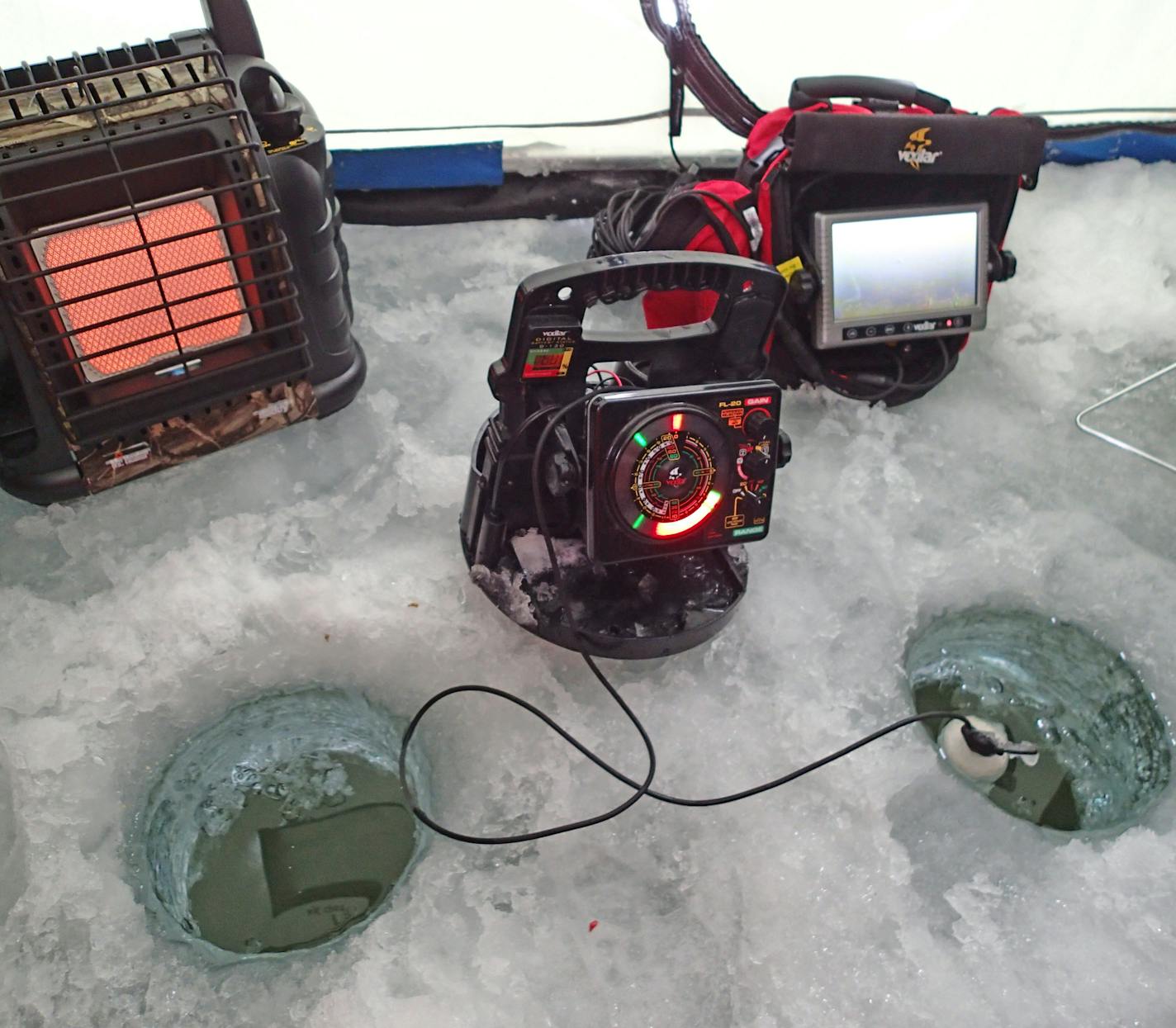 Gadget city The modern ice angler is warm in an oftentimes portable shelter, with a flasher (depth finder) that can show fish moving toward a bait, and even an underwater camera, right.&#xad;