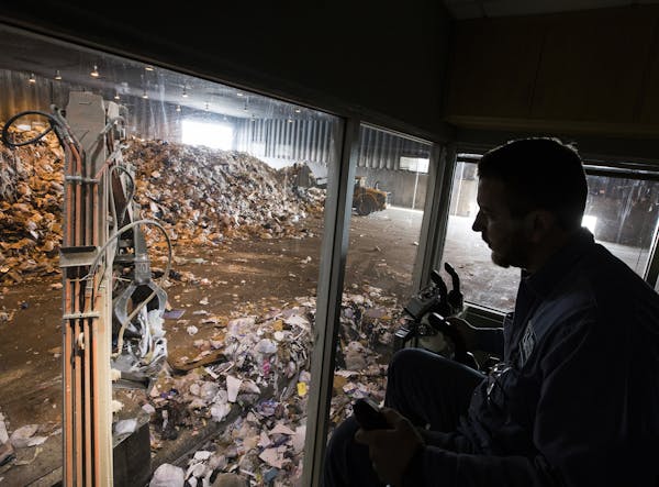 Grapple crane operator and processor Cody Atkinson looks for items to remove from solid waste that may damage processing equipment at Elk River Resour