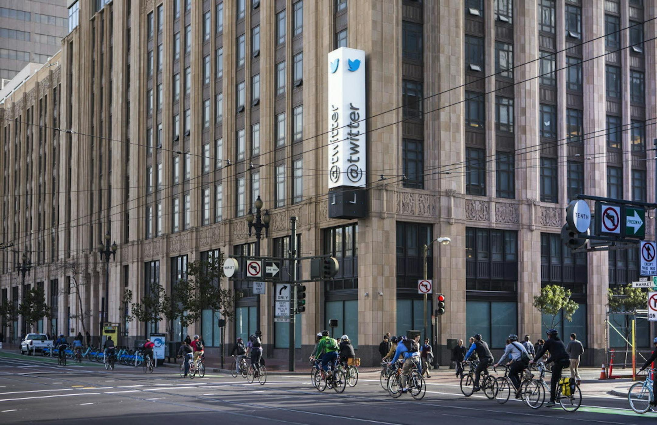 Bicyclists ride down Market Street past Twitter headquarters in San Francisco on November 7, 2013. (John Green/Bay Area News Group/TNS) ORG XMIT: 1206970