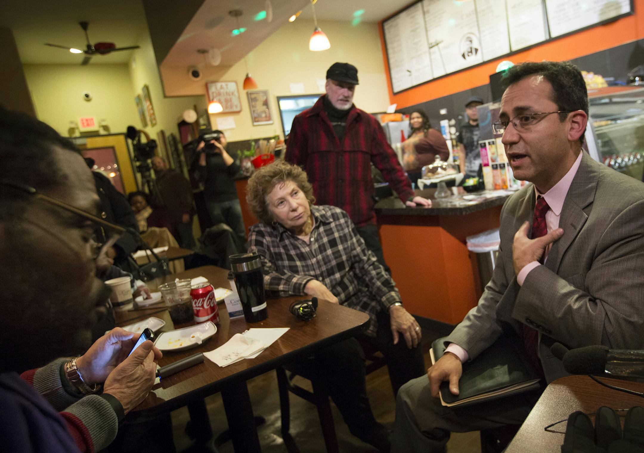 Sergio Paez spoke to the media and members of the public that showed up to question him in his continuing mission to secure the job of superintendent of Minneapolis Public Schools at Sammy'a Avenue Eatery on Tuesday, January 5, 2015, in Minneapolis, Minn. The woman at left is Ruth Usen who came to ask some questions.