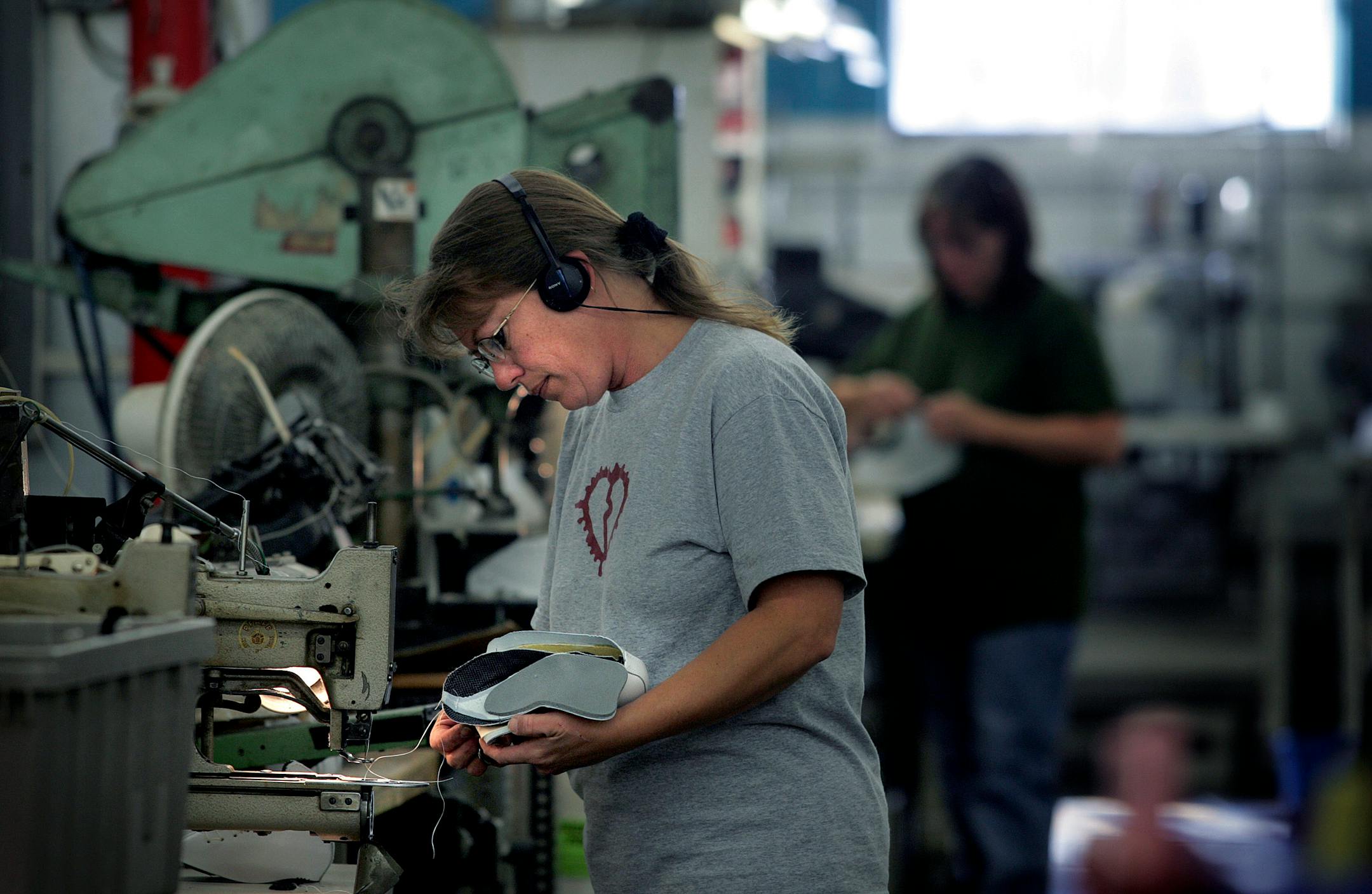 Riedell Skate Company's Ann Diercks, foreground, attached the tongue to the upper part of a skate boot. Much of the work at the factory is done by hand, and some elite figure skaters order custom built boots.