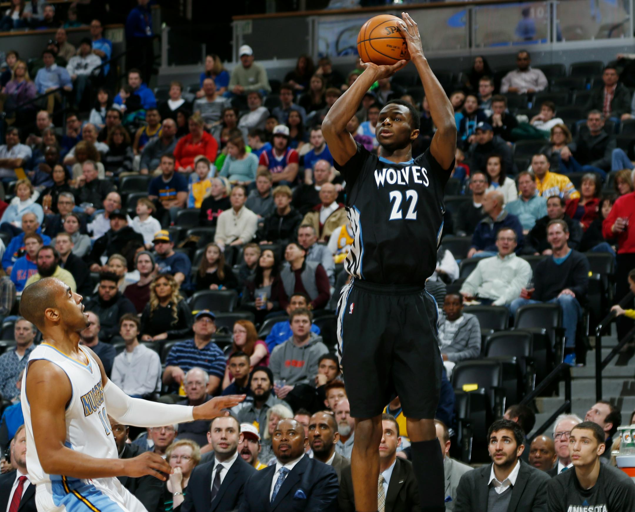 Minnesota Timberwolves guard Andrew Wiggins, right, goes up to shoot over Denver Nuggets guard Arron Afflalo in the first quarter of an NBA basketball game Saturday, Jan. 17, 2015, in Denver. (AP Photo/David Zalubowski)