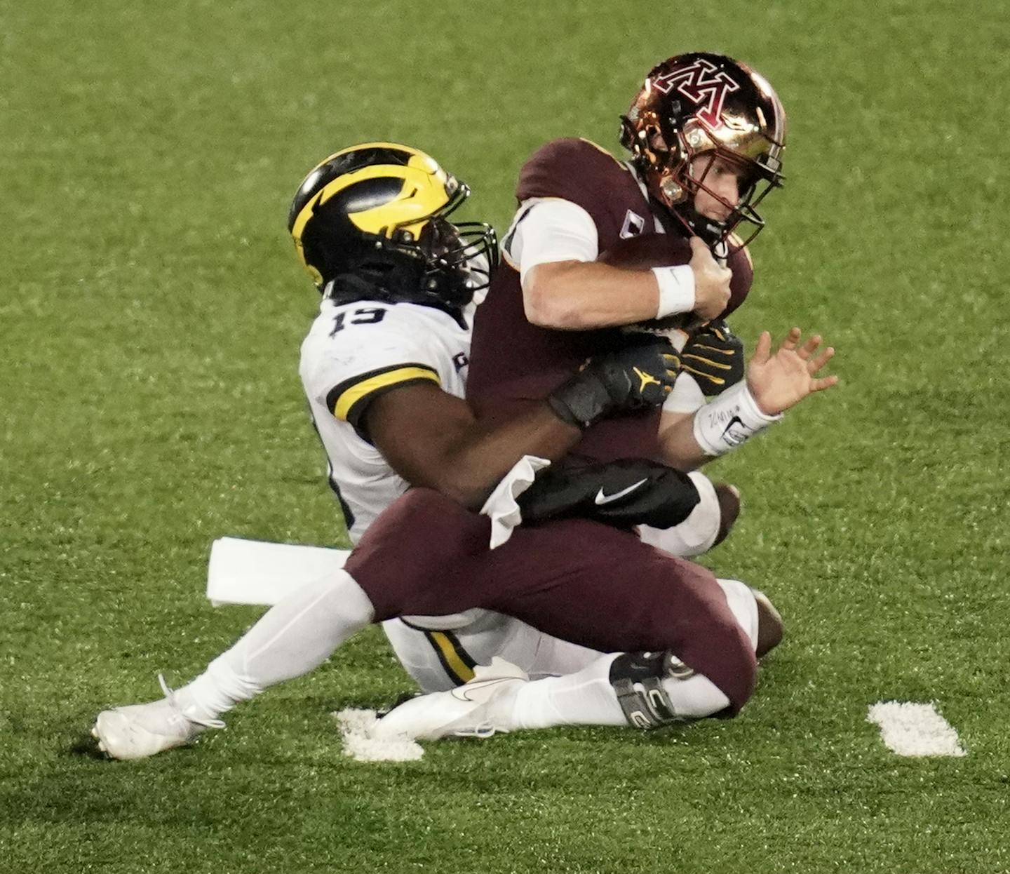 Minnesota Gophers quarterback Tanner Morgan (2) is sacked by Michigan Wolverines defensive lineman Kwity Paye (19) in the fourth quarter. ] Mark Vancleave Ð The Minnesota Gophers played the Michigan Wolverines on Saturday, Oct. 24, 2020 at TCF Bank Stadium in Minneapolis. ORG XMIT: MIN2010242147520208