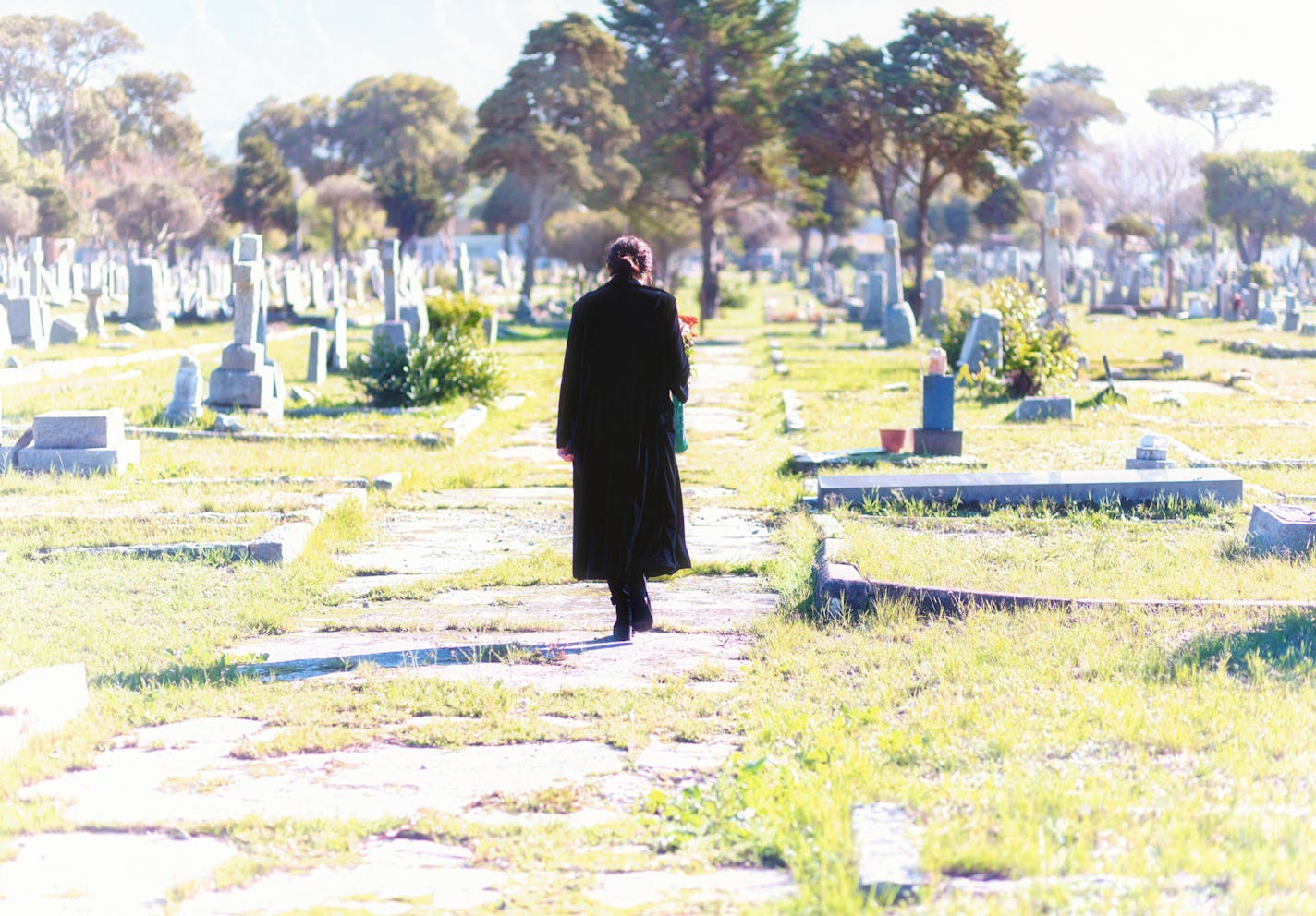 Young woman in a graveyard.