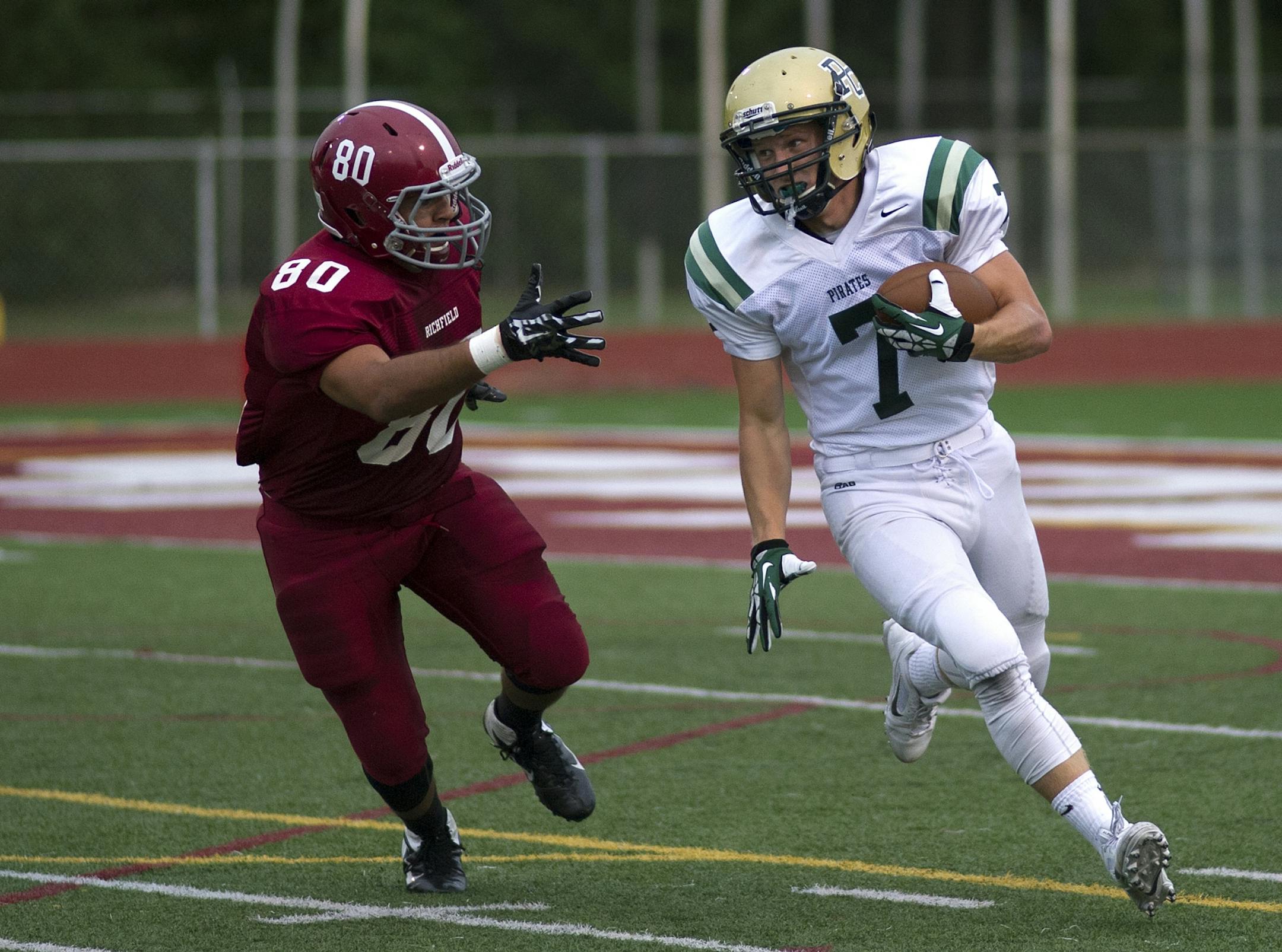 Richfield's Cruz Carillo pursues Park Center's Adam Buirge during Friday night's game at Richfield. The 2014 season begins for most teams this Thursday and Friday.