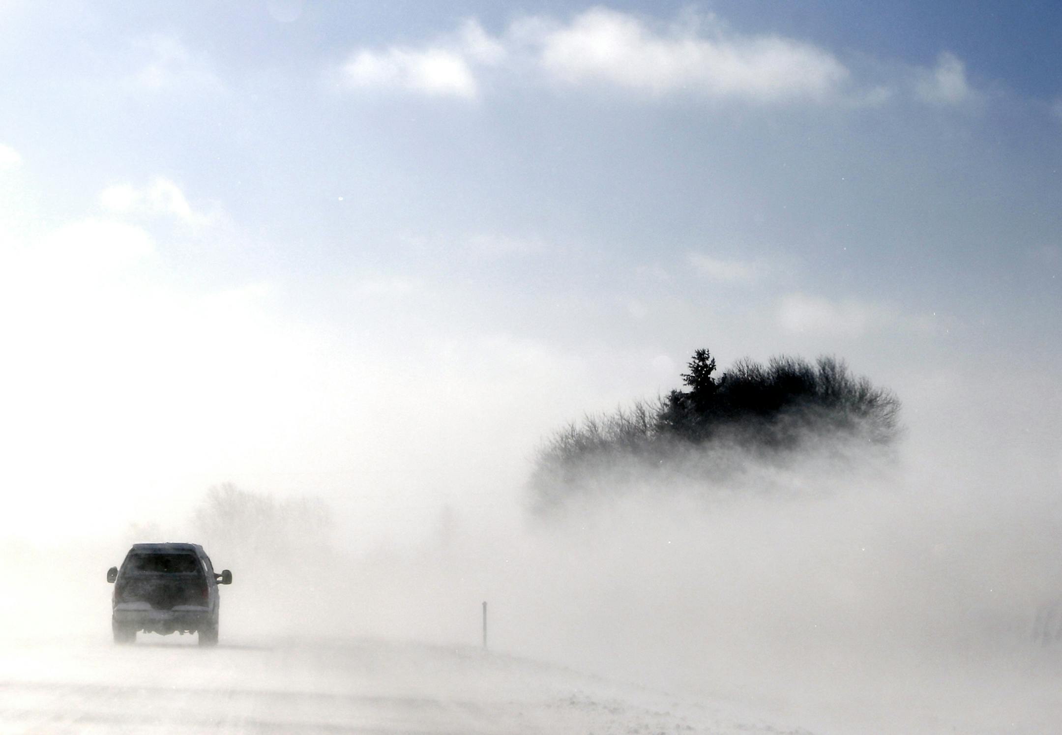 Blizzard-like conditions near along I-35 Friday, Feb. 21, 2014, MN. I-35 to the south at Owatonna, MN into Iowa because of blizzard conditions. A vehicle travels on I-35 south in whiteout conditions near Fairibault, MN.