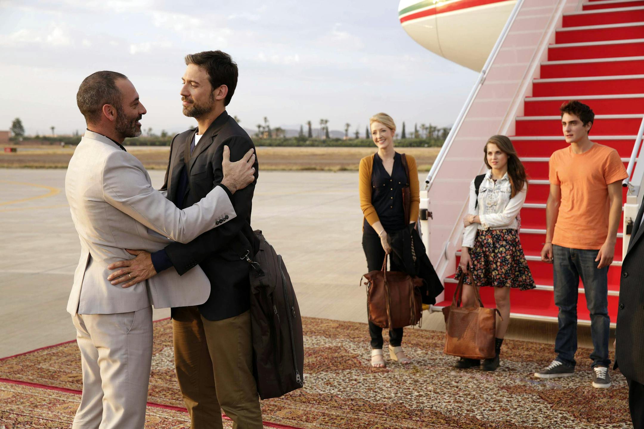 This image released by FX shows Ashraf Barhom, from left, Adam Rayner, Jennifer Finnegan, Anne Winters and Noah Silver in a scene from "Tyrant," premiering June 24. The series focuses on the youngest son of a Middle Eastern nation's dictator who returns from America after 20 years for his nephew's wedding, only to be thrown back into the turbulent familial and national politics of his youth. (AP Photo/FX, Patrick Harbron)