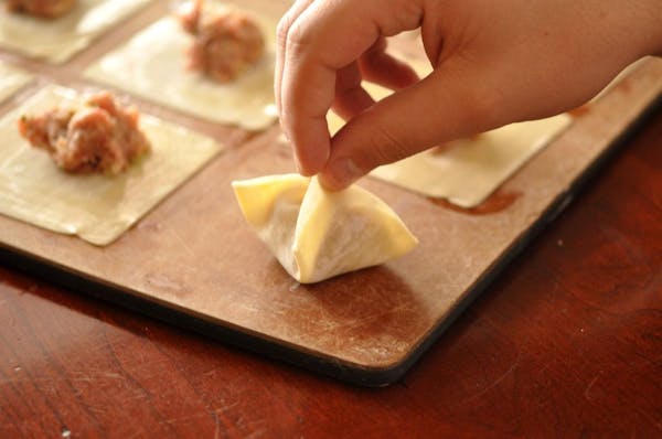 Many hands make quick work of potstickers.
