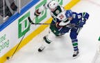 Wild defenseman Ryan Suter (20) battled Vancouver's Jay Beagle as the teams met in an NHL postseason game in Edmonton on Aug. 2. The Wild's season end