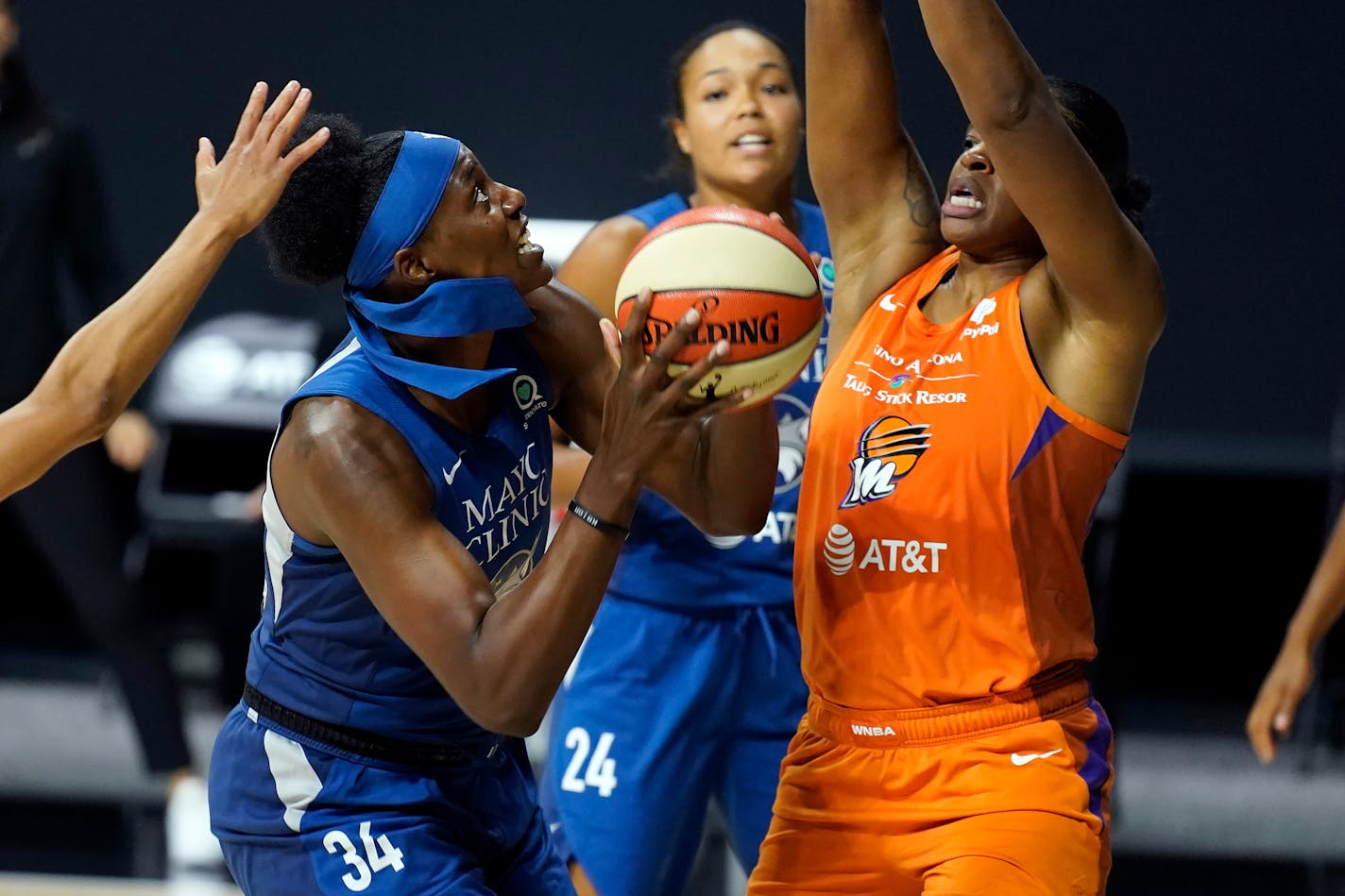 Minnesota Lynx center Sylvia Fowles (34) goes up against Phoenix Mercury center Kia Vaughn (1) during the second half of a WNBA playoff basketball game Thursday, Sept. 17, 2020, in Bradenton, Fla. (AP Photo/Chris O'Meara)