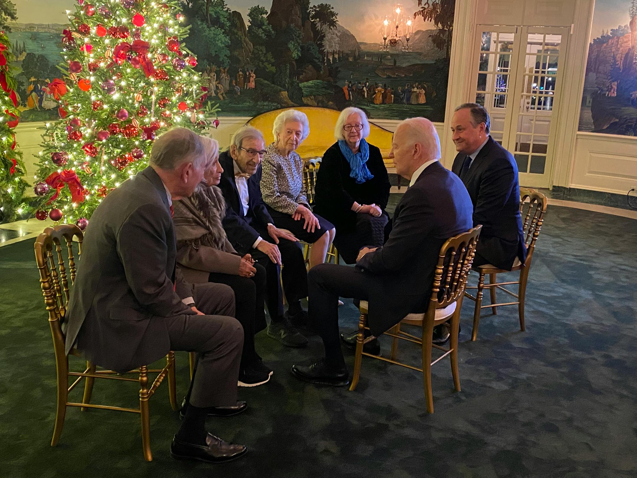 Dreier, center, and other Holocaust survivors meet President Biden at the 2023 White House Hanukkah party. MUST CREDIT: Courtesy of Justyna Kołaczek
