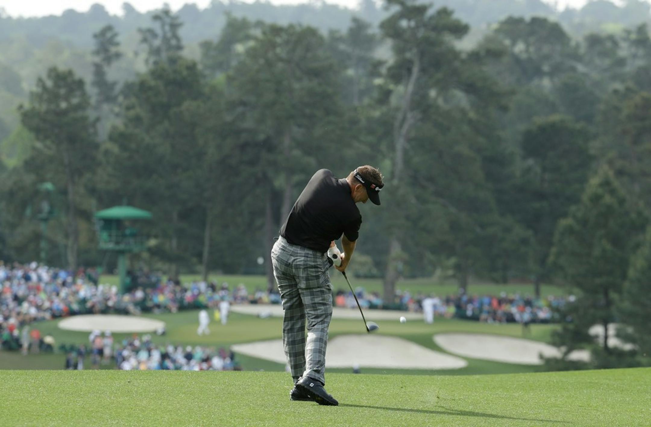 Ian Poulter plays in the rain Friday.