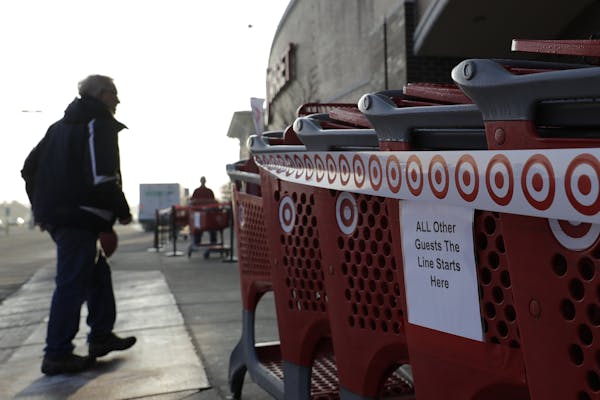 A sign displays outside of a Target store in Glenview, Ill., Wednesday, March 25, 2020. Grocery store chains and other retailers began offering specia