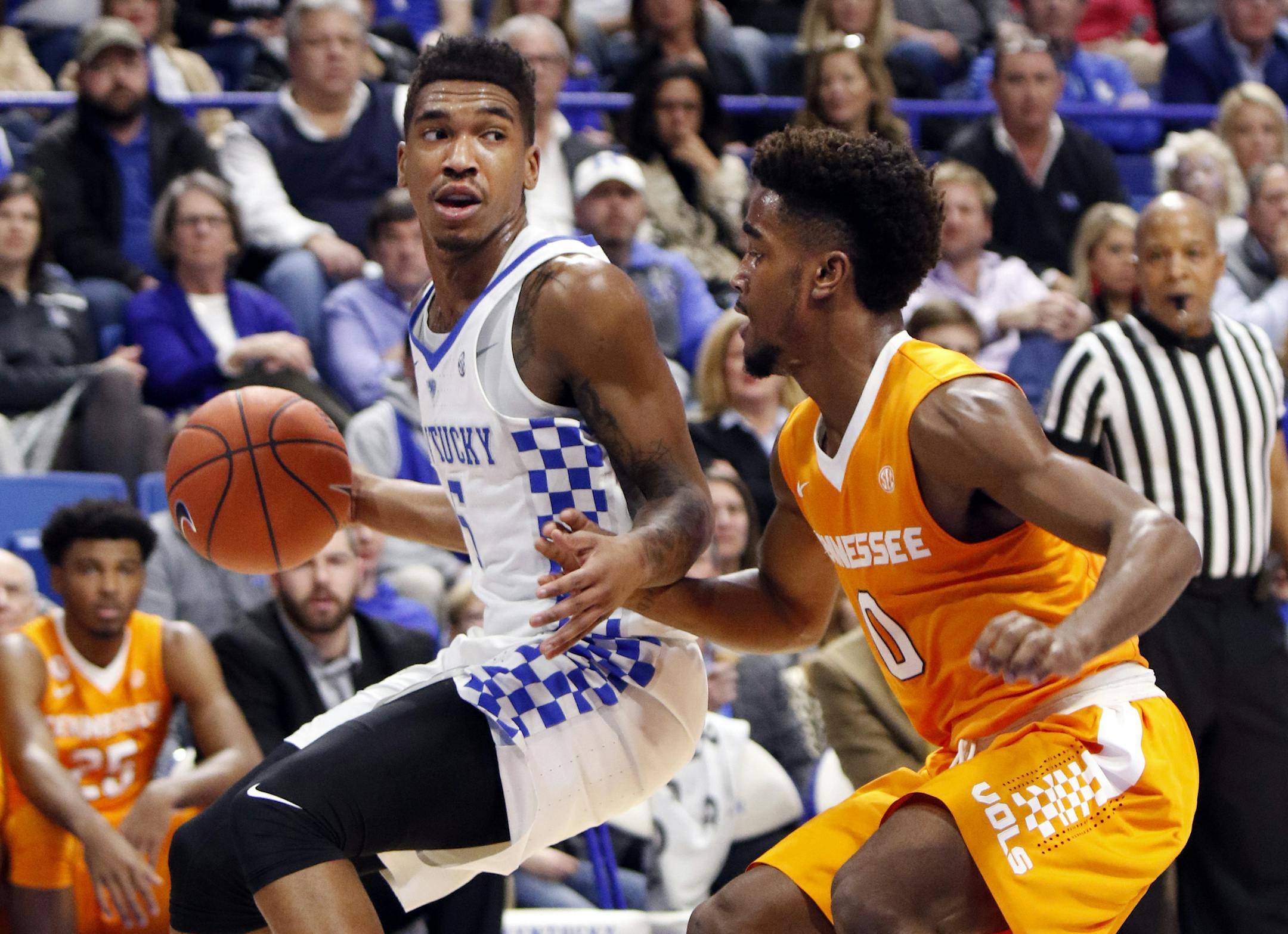 Kentucky's Malik Monk, left, looks for an opening as Tennessee's Jordan Bone (0) defends during the first half of an NCAA college basketball game, Tuesday, Feb. 14, 2017, in Lexington, Ky. (AP Photo/James Crisp)