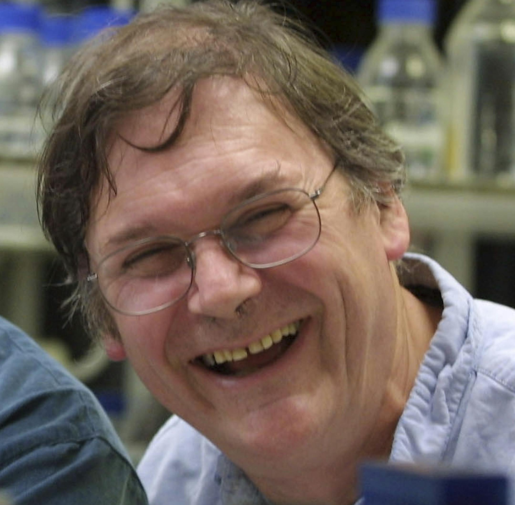 FILE - A Monday Oct. 8, 2001 photo from files of Dr. Tim Hunt, winner of the Nobel Prize for Medicine, in a laboratory in London. The Nobel Prize-winning British scientist has apologized Wednesday, June 10, 2015, for saying the "trouble with girls" working in science labs is that it leads to romantic entanglements and harms science. Tim Hunt made the comments at the World Conference of Science Journalists in South Korea, according to audience members. (AP Photo/Alastair Grant, File)