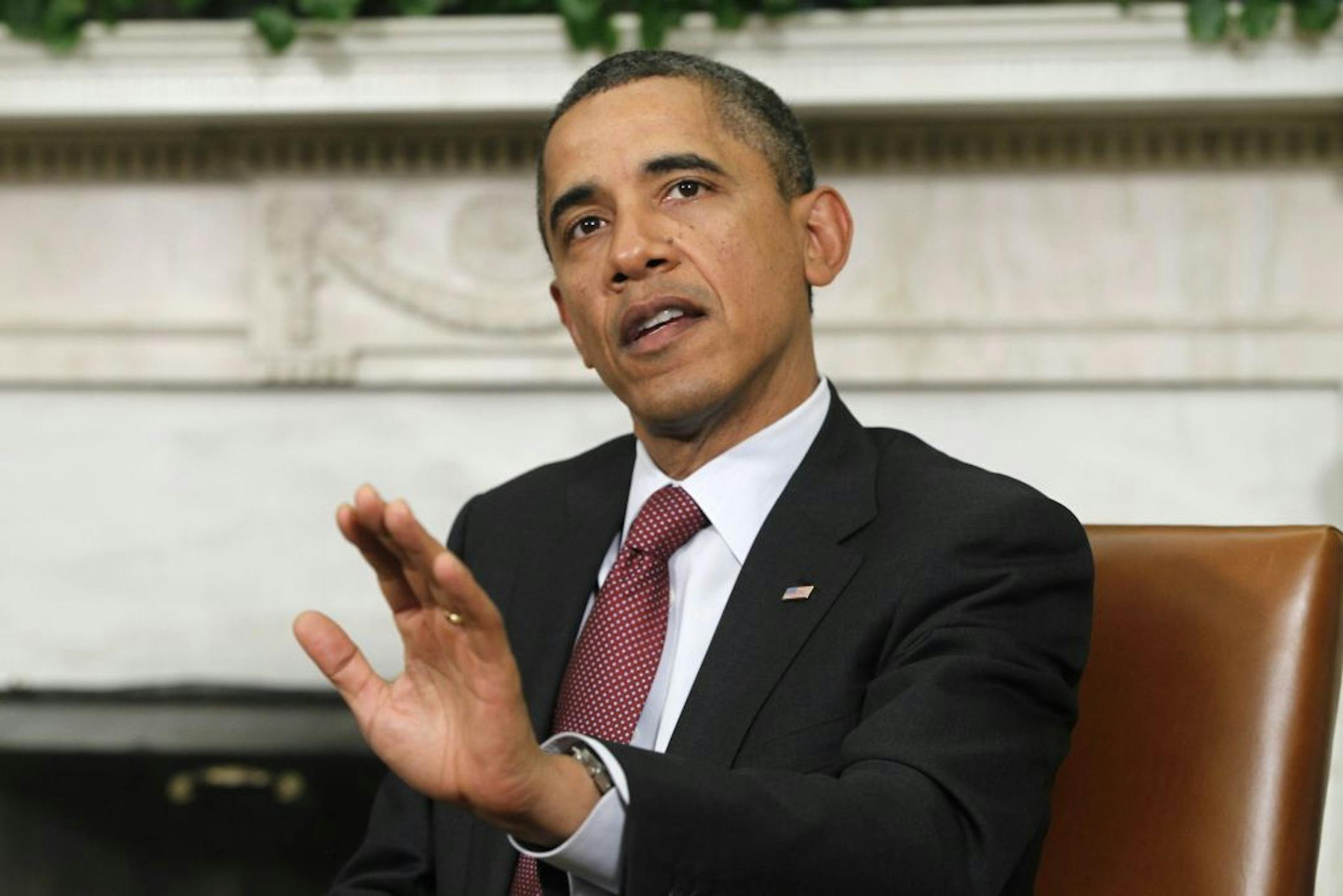 President Barack Obama answers a reporter's question about the European debt deal as he meets with Czech Prime Minister Petr Necas, not shown, Thursday, Oct. 27, 2011, in the Oval Office of the White House in Washington.