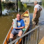 Royal Myers holds a gift bag of wine on his return canoe trip from the Northern Lights Dental clinic in Waterville, Minnesota.