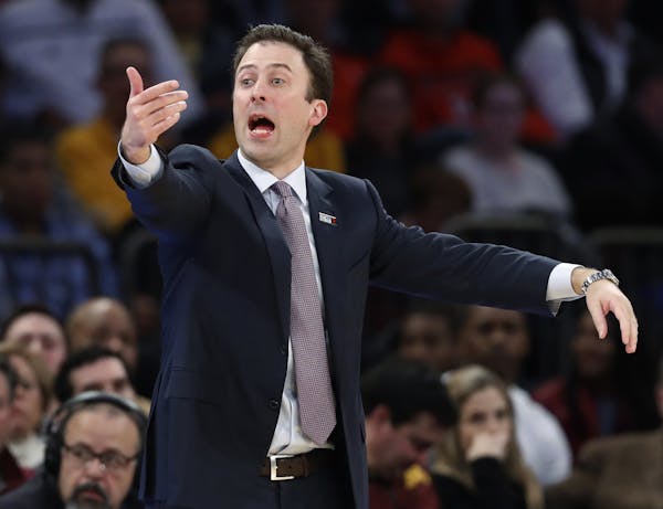 Minnesota coach Richard Pitino gestures during the first half of the team's NCAA college basketball game against Rutgers in the first round of the Big