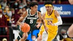 Michigan State guard Max Christie, left, brings the ball down court past Minnesota guard Eylijah Stephens during the second half Dec. 8, 2021.