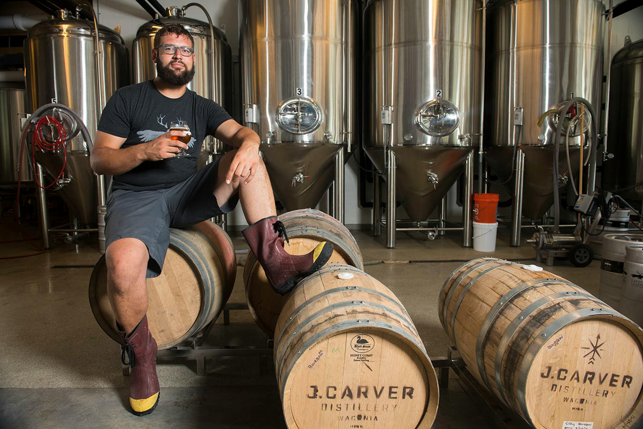 Andrew Dimery, head brewer at Lakes & Legends Brewing Company, sat for a portrait in his brewery.