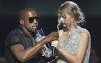 FILE-This Sept. 13, 2009 file photo shows singer Kanye West taking the microphone from singer Taylor Swift as she accepts the "Best Female Video" awar