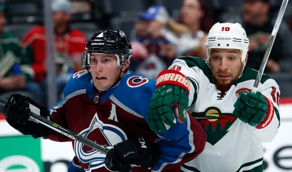 Avalanche defenseman Tyson Barrie, left, fought for position in front of the net with Wild right winger Chris Stewart in the second period Sunday.