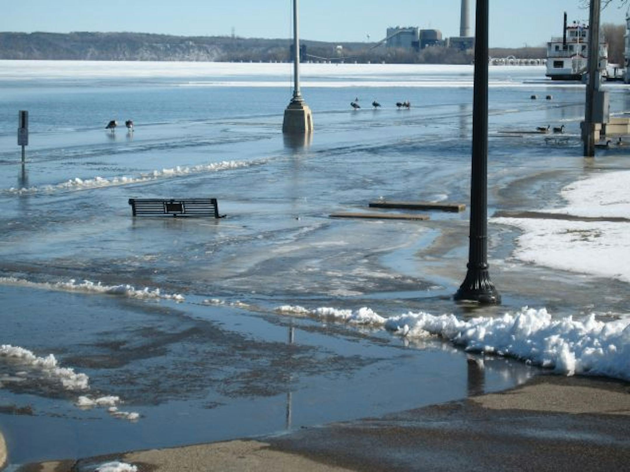Photo by Kevin Giles Flooding on the St. Croix River swamped most of Stillwater�s Lowell Park last week. This view, looking south from the Lift Bridge, shows rising water even as most of the river remains under ice. Police Chief John Gannaway said the river�s second crest, expected within the week, could be worse depending on the amount of rain that falls. Most of the St. Croix remains under ice. Preparations continue in other river cities such as Bayport, Lake St. Croix Beach and Afton to prepa