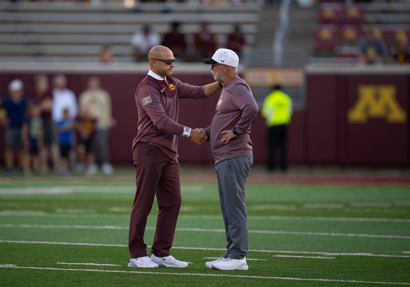 Minnesota Gophers head coach P.J. Fleck, left, and New Mexico State Aggies head coach Jerry Kill exchanged greetings on the field as their teams warmed up before their game at Huntington Bank Stadium in Minneapolis Thursday night, September 1, 2022. The University of Minnesota Gophers faced the New Mexico State Aggies in the opening football game of the season. ] JEFF WHEELER • Jeff.Wheeler@startribune.com