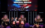 The caskets representing the fallen are brought into the sanctuary at Grace Church before the start of the memorial service. Photos of Burnsville poli