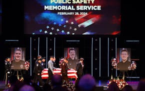 The caskets representing the fallen are brought into the sanctuary at Grace Church before the start of the memorial service. Photos of Burnsville poli