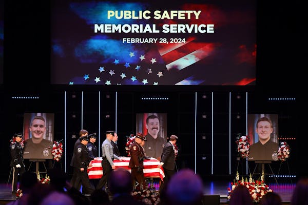 The caskets representing the fallen are brought into the sanctuary at Grace Church before the start of the memorial service. Photos of Burnsville poli