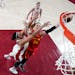 Spain's Laura Gil drives to the basket ahead of Canada's Natalie Achonwa, left, during a women's basketball preliminary round game