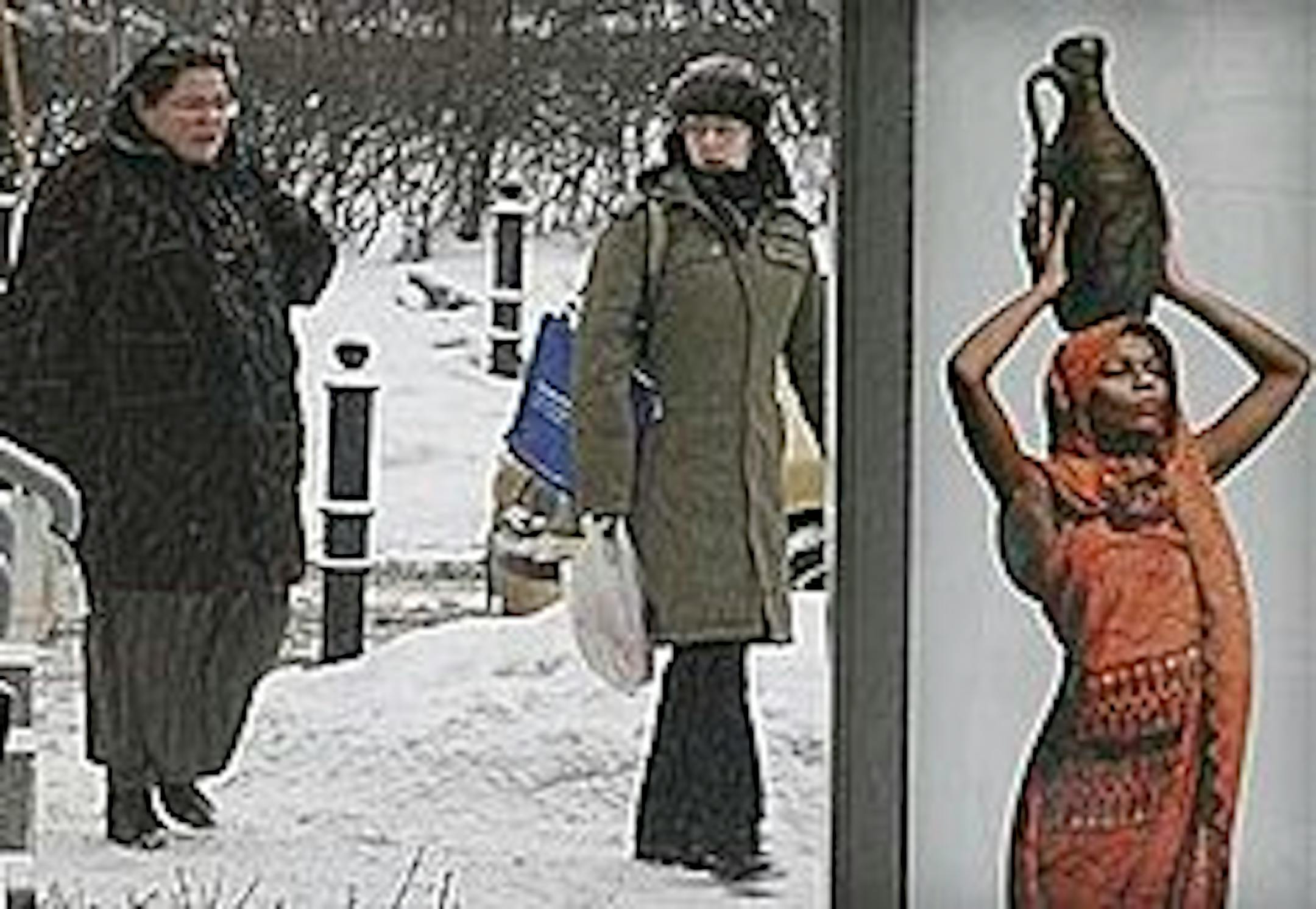 Women walk past an advertising board on a snow covered street in Warsaw, Poland, Thursday, Feb. 11 2010. (AP Photo/Czarek Sokolowski)