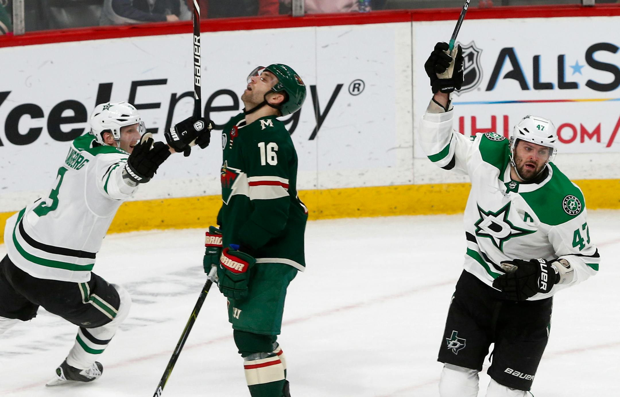 Dallas Stars' Alexander Radulov, right, of Russia, and John Klingberg, left, of Sweden, celebrate Radulov's game-winning goal in overtime as Minnesota Wild's Jason Zucker reacts in an NHL hockey game Saturday, Dec. 22, 2018, in St. Paul, Minn. The Stars won 2-1. Zucker tied the game with a third period goal. (AP Photo/Jim Mone)