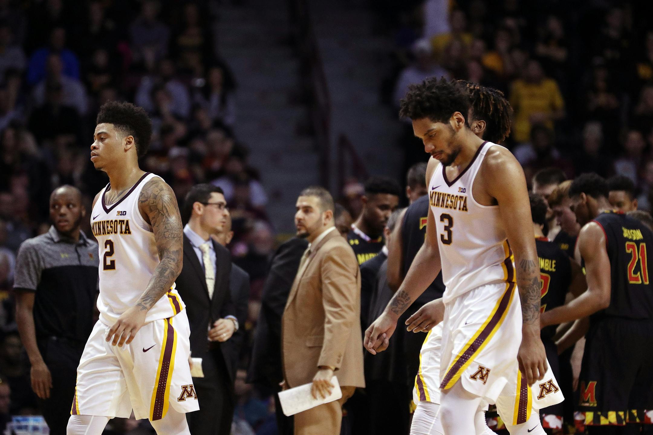 Minnesota Gophers guard Nate Mason (2) leads his team to the bench for a timeout during the second half.