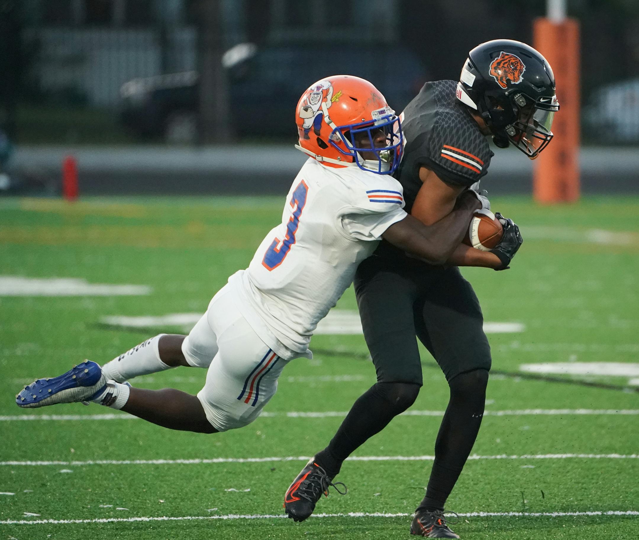 Minneapolis South wide receiver Kader Diop (23) is wrapped up by Washburn wide receiver Zyaire Marshall (3) in the first half. ] Shari L. Gross • shari.gross@startribune.com Minneapolis South hosted Washburn High School for a football game on Friday night, Sept. 20, 2019. South's homecoming was the first game played under the new stadium lights.