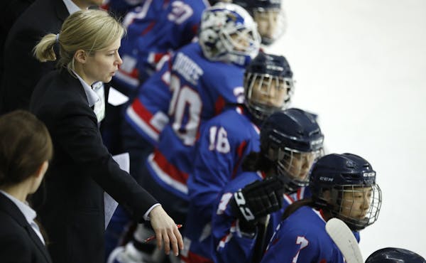 Combined Koreas head coach Sarah Murray, left, watches a women's ice hockey friendly game between her team and Sweden at Seonhak International Ice Rin