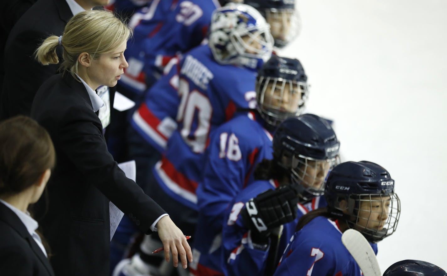 Combined Koreas head coach Sarah Murray, left, watches a women's ice hockey friendly game between her team and Sweden at Seonhak International Ice Rink in Incheon, South Korea, Sunday, Feb. 4, 2018. (Kim Hong-Ji/Pool Photo via AP)