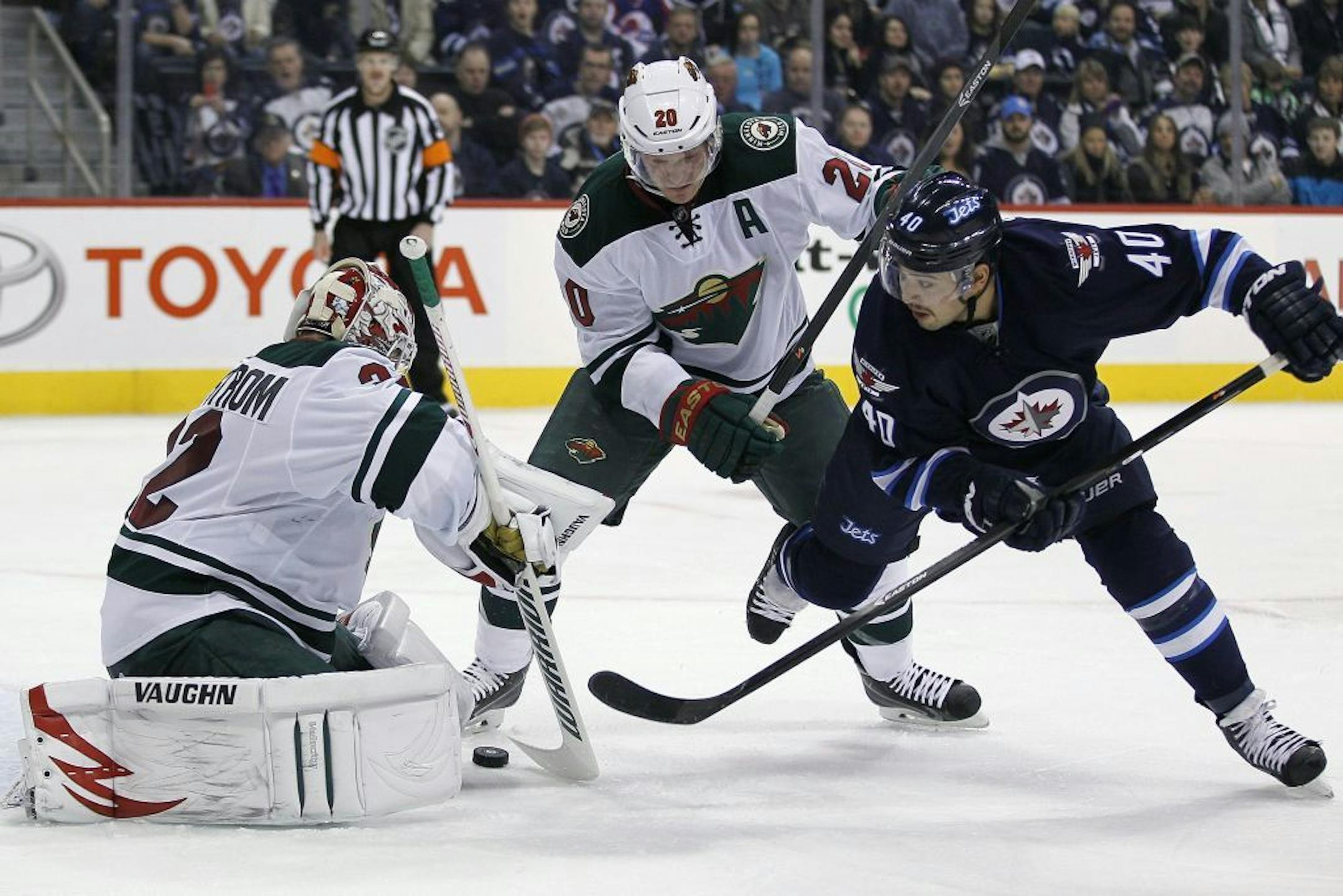 Wild goaltender Niklas Backstrom stopped a shot from the Jets' Devin Setoguchi (40) as Wild defenseman Ryan Suter forced Setoguchi off the rebound during the second period Saturday.