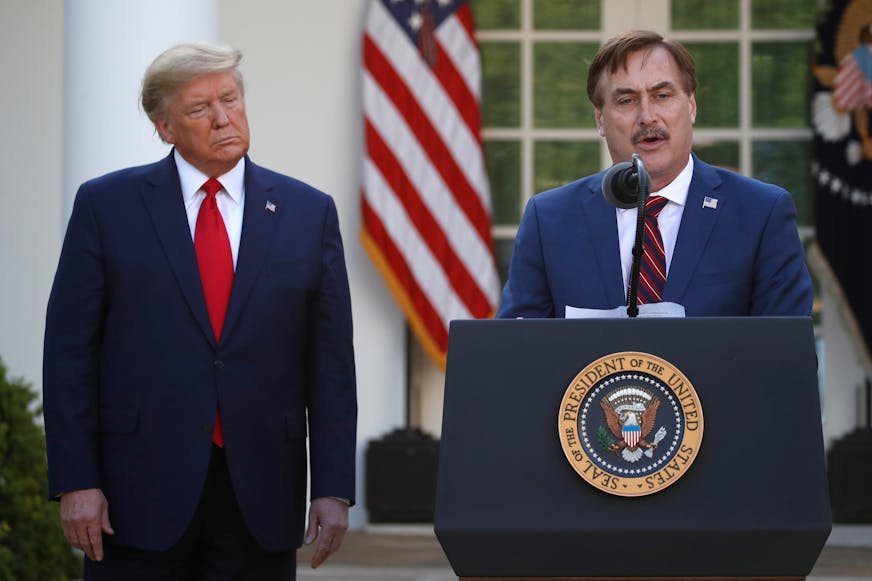 FILE - In this March 30, 2020 file photo, My Pillow CEO Mike Lindell speaks as President Donald Trump listens during a briefing about the coronavirus in the Rose Garden of the White House, in Washington. Lindell, is weighing a run for governor in Minnesota. If he follows through on a campaign, it could be an early test of where the Republican Party is headed in the post-Donald Trump era. (AP Photo/Alex Brandon, File) ORG XMIT: MER91a39036b4955bca39a2324a7a8a6