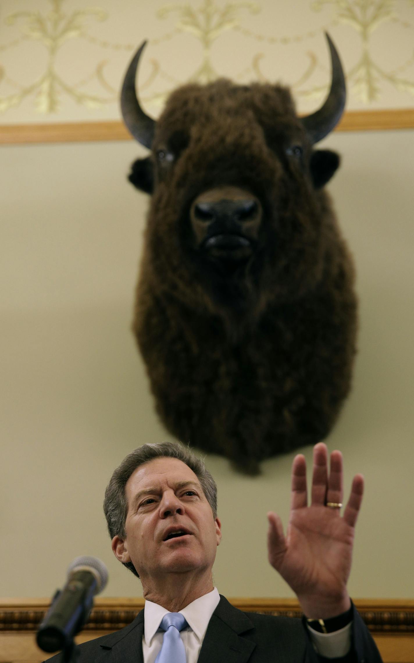 Kansas Gov. Sam Brownback talks to the media during a news conference Thursday, July 27, 2017, in Topeka, Kan. President Donald Trump on Wednesday nominated Brownback to be ambassador-at-large for international religious freedom. (AP Photo/Charlie Riedel) ORG XMIT: KSCR106