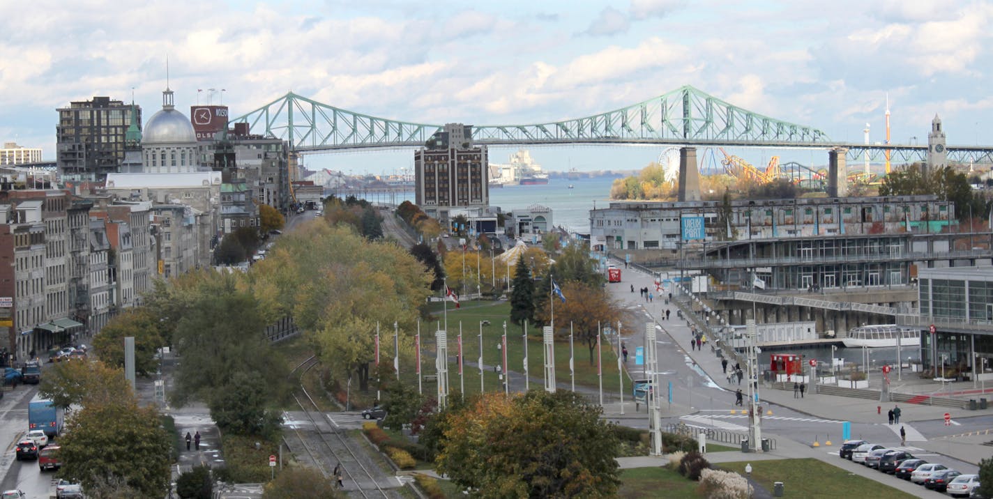 This Oct. 22, 2013 photo shows the Old Port and Old Montreal along the St. Lawrence River. Visitors can stroll the neighborhoods for a free feel of the city&#xed;s French and English cultures. (AP Photo/Caryn Rousseau) ORG XMIT: RPCR802