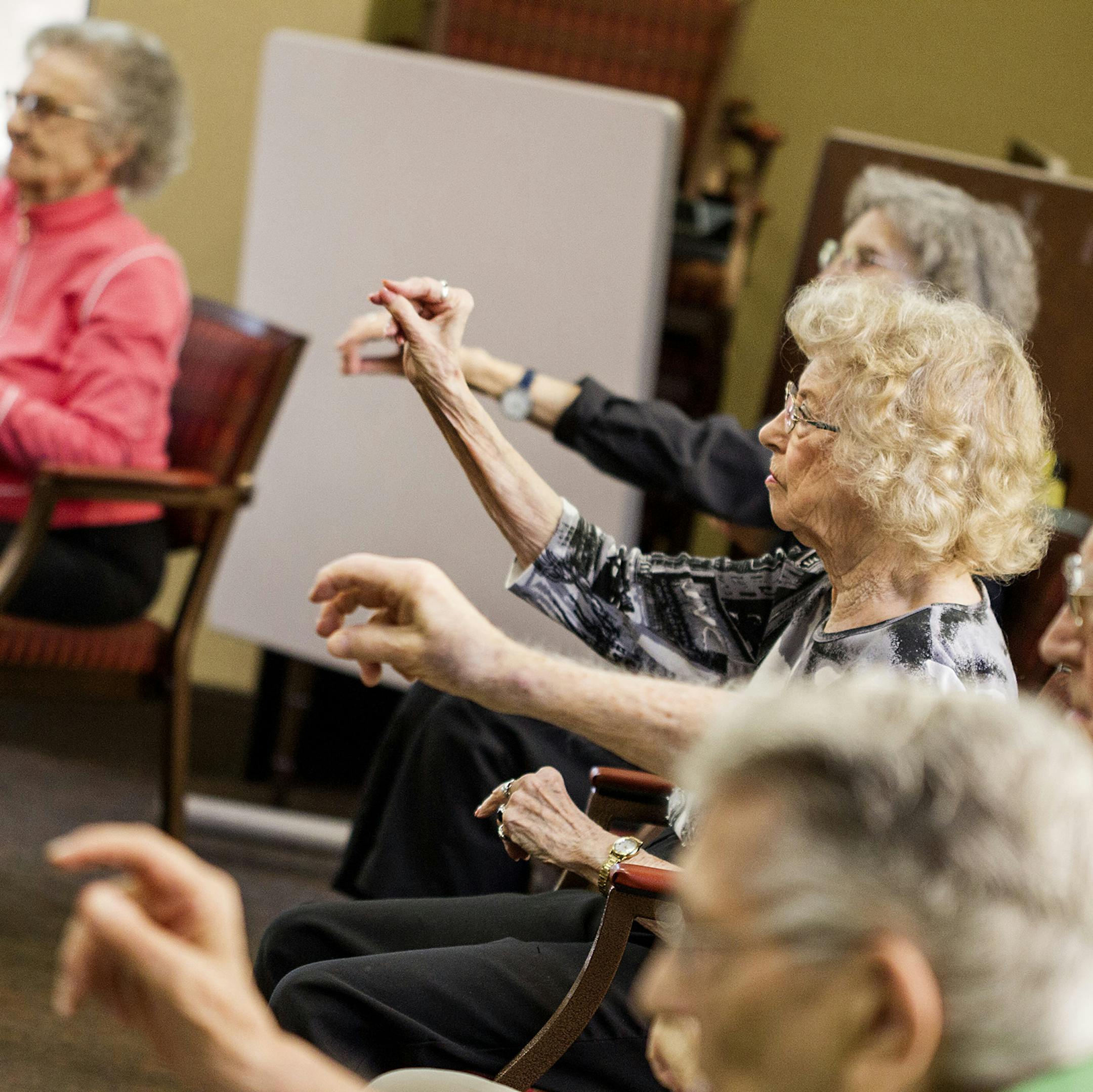 Residents move their bodies as they participate in Ageless Grace, a Senior Sneakers Flex class, at The Wellington in St. Paul July 16, 2014. (Courtney Perry/Special to the Star Tribune)