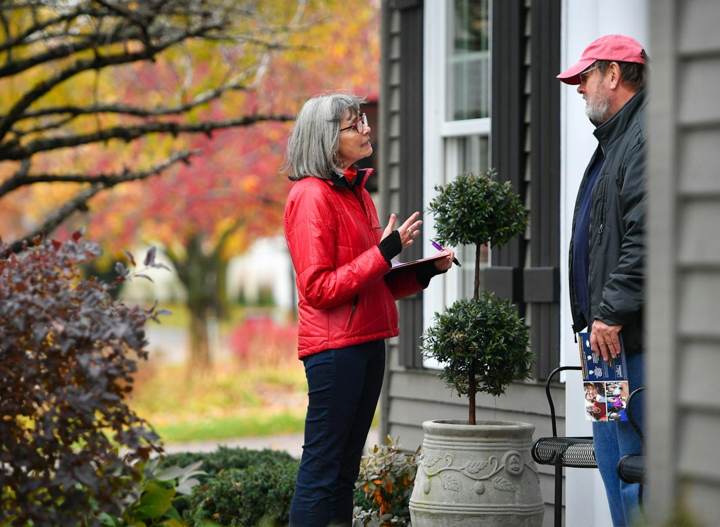 Making her pitch: Ginny Klevorn, a DFL challenger, knocked on doors in Plymouth neighborhood, here with Tom Lucas.