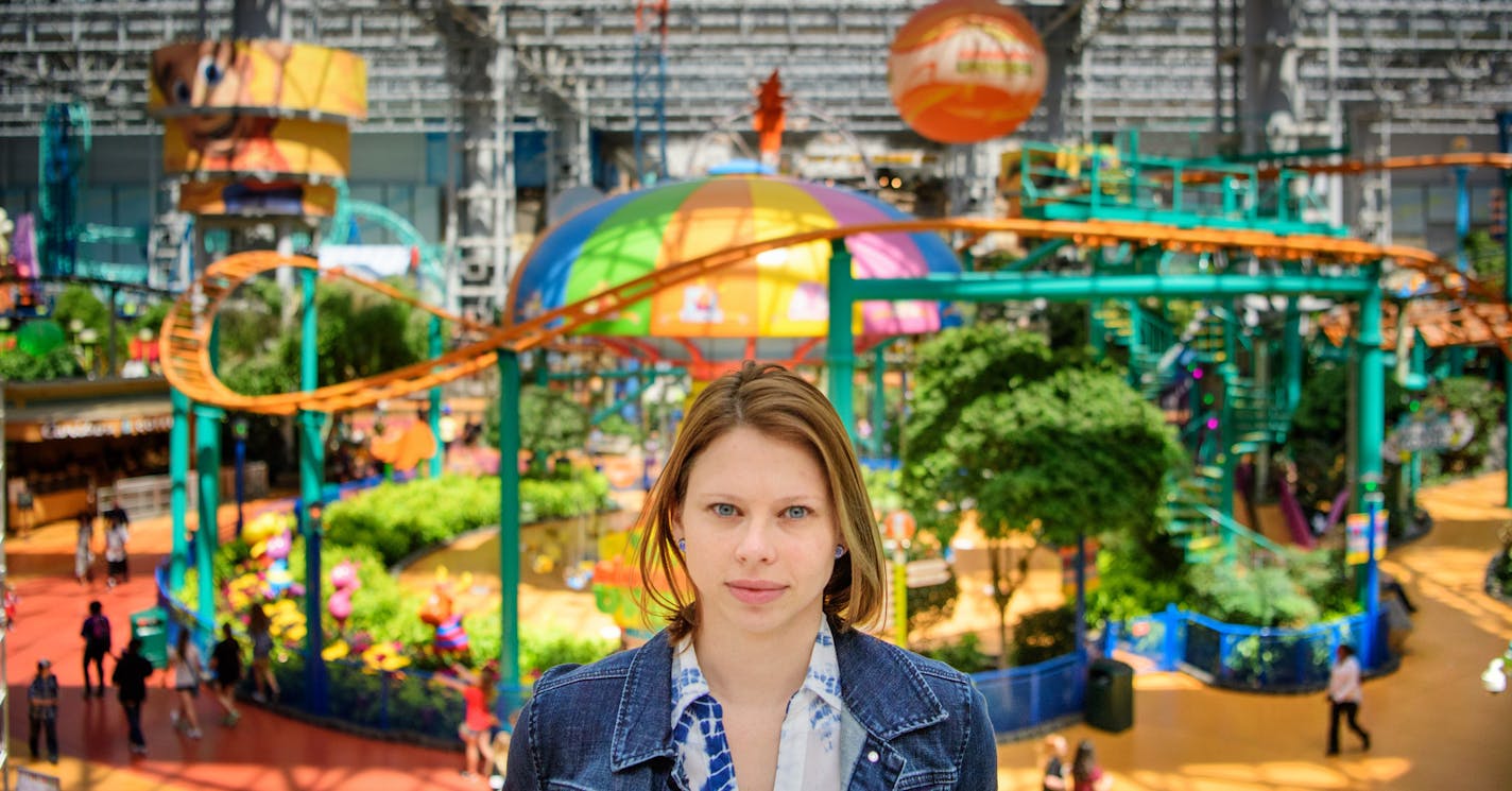 Jess Nelson, MOA case manager for Oasis For Youth, walks through Nickelodeon Universe talking with young employees.