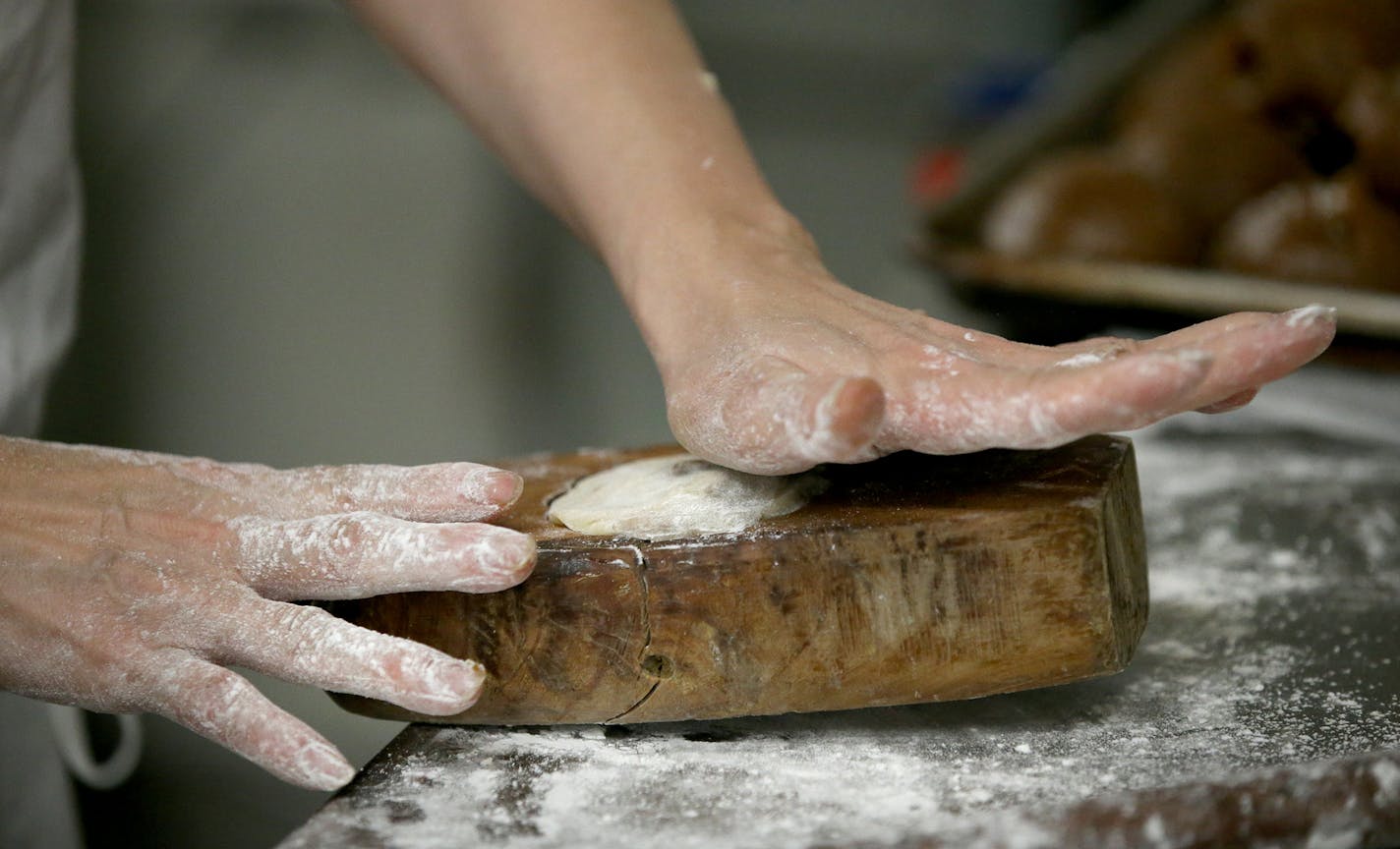 Pauline Kwan made mooncakes ahead of the lunar calendar harvest holiday that begins on Monday. Mooncakes are a specialty at the Mid-Autumn Festival and this is one of the only places in the Twin Cities where they are made. Here, Kwan, who has been making mooncakes for 35 years, stuffs the dough and filling into a wooden mold to form a moonlike before baking and seen Wednesday, Sept. 18, 2018, in Minneapolis, MN.] DAVID JOLES &#xef; david.joles@startribune.com Michelle Kwan is taking over the run