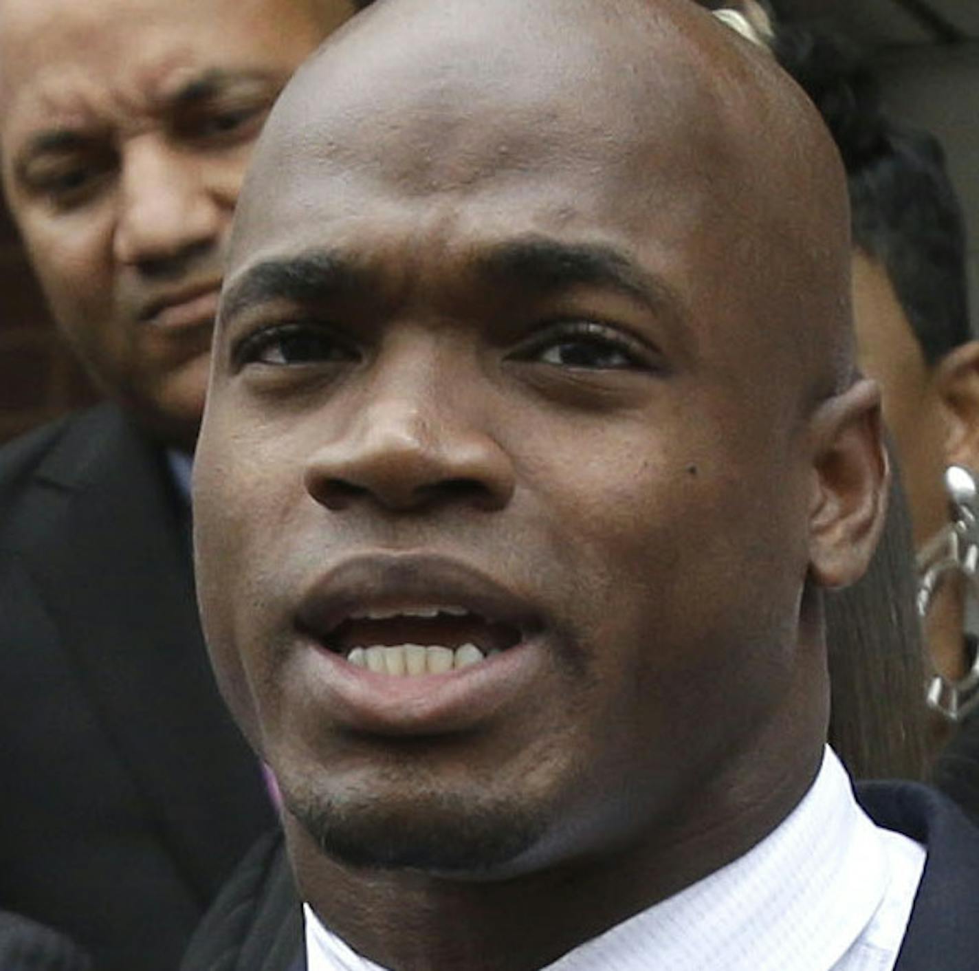 Minnesota Vikings running back Adrian Peterson, center, and his attorney Rusty Hardin, left, speak to the media after pleading no contest to an assault charge Tuesday, Nov. 4, 2014, in Conroe, Texas. Adrian Peterson avoided jail time on Tuesday in a plea agreement reached with prosecutors to resolve his child abuse case. (AP Photo/Pat Sullivan)